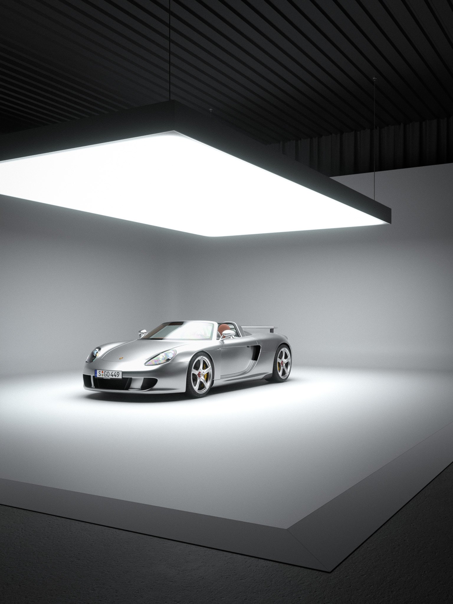 Carrera GT under a large overhead softbox in a virtual studio